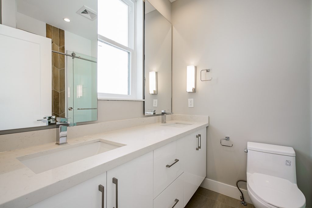 Clean Toilet with Washbasin and Mirrors